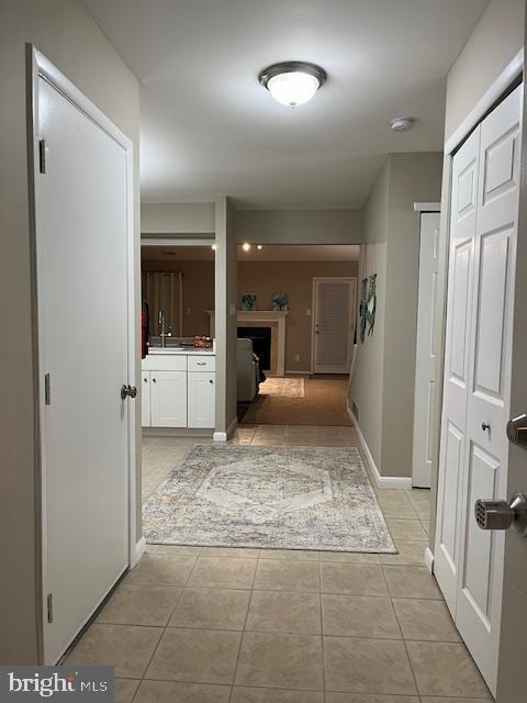 corridor featuring light tile patterned floors