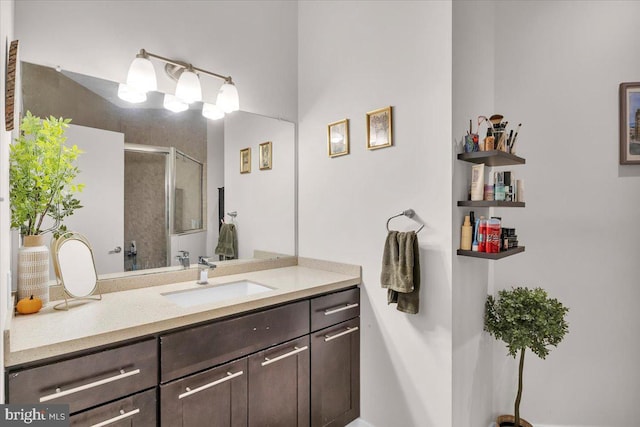 bathroom featuring an enclosed shower and vanity