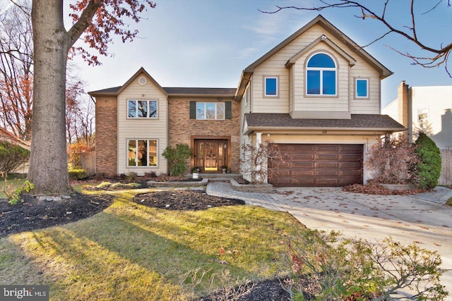 view of property featuring a front yard and a garage