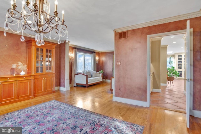 unfurnished room with light wood-type flooring, crown molding, and a wealth of natural light