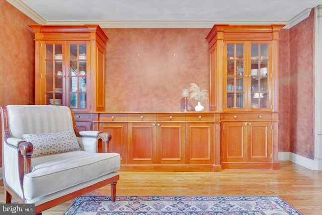 living area featuring light hardwood / wood-style flooring and ornamental molding