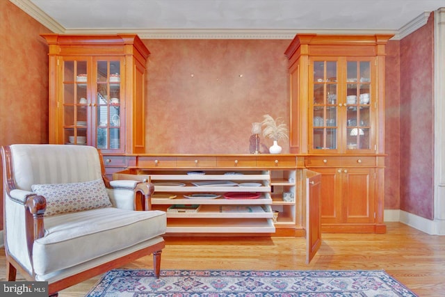 sitting room featuring ornamental molding and light hardwood / wood-style floors