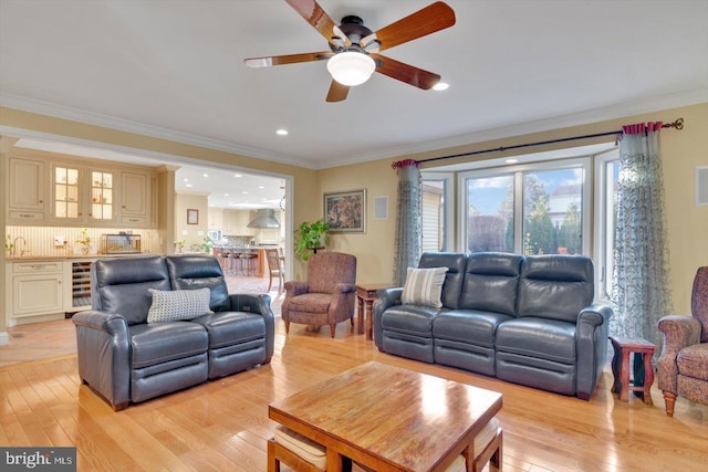 living room featuring light wood-type flooring and crown molding