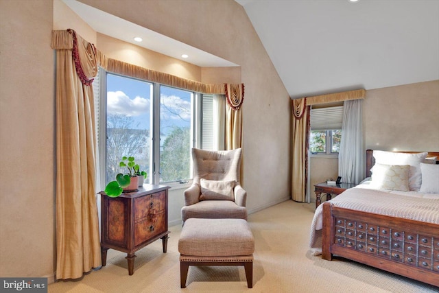 bedroom featuring multiple windows, light carpet, and high vaulted ceiling