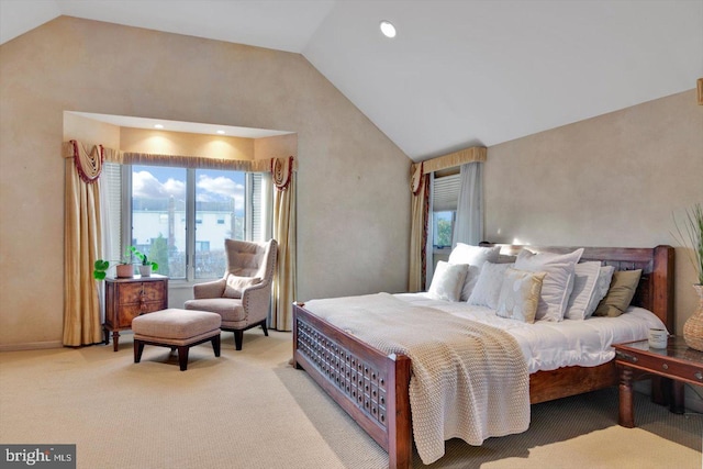 bedroom featuring high vaulted ceiling and light carpet