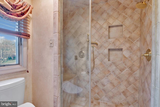 bathroom with toilet and tiled shower