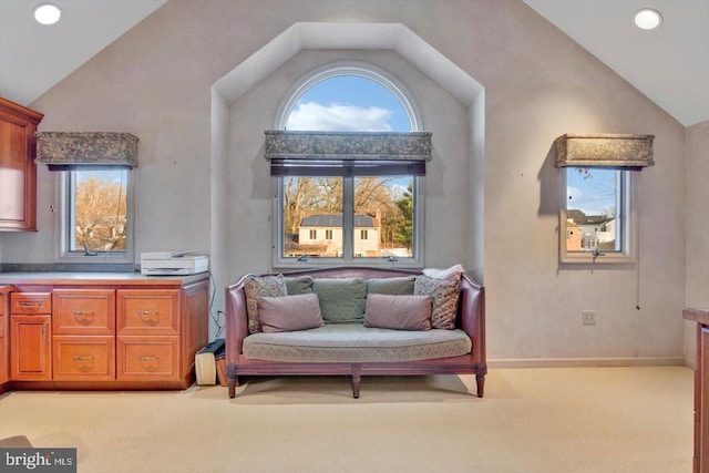 sitting room featuring vaulted ceiling and light colored carpet