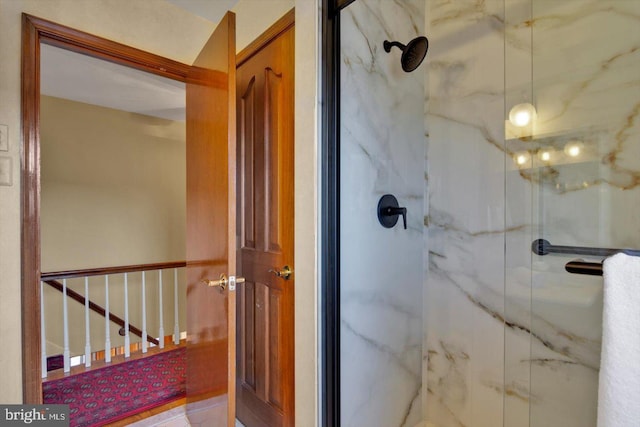 bathroom with a shower with door