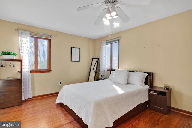 bedroom with ceiling fan and wood-type flooring