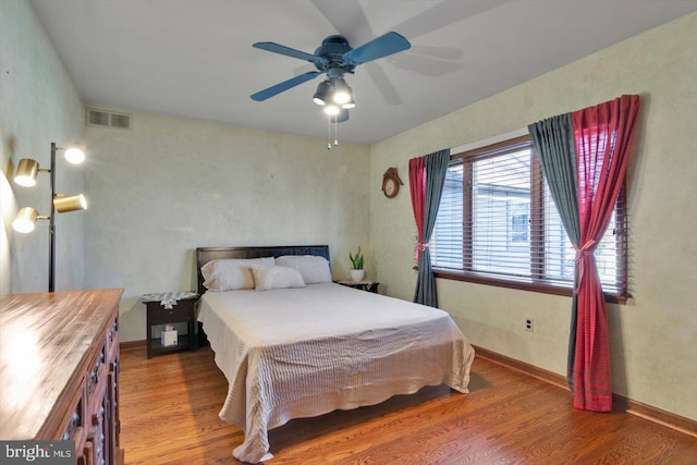 bedroom with ceiling fan and hardwood / wood-style floors