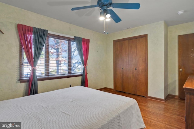 bedroom featuring a closet, hardwood / wood-style flooring, and ceiling fan