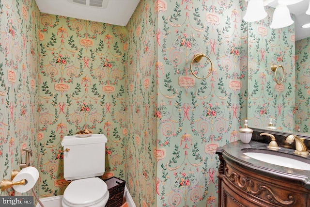 bathroom featuring toilet and vanity