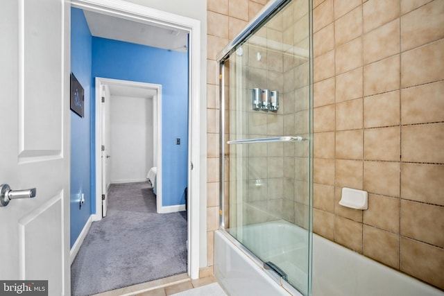 bathroom with shower / bath combination with glass door