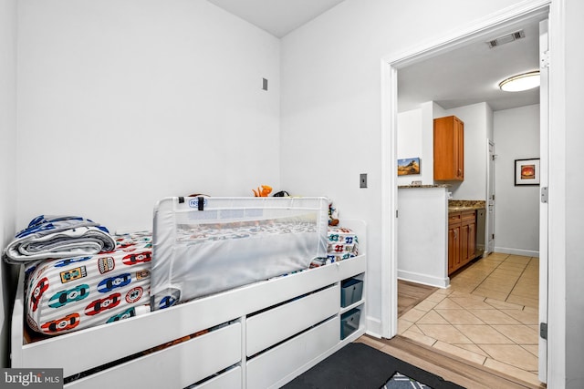 bedroom with light tile patterned floors