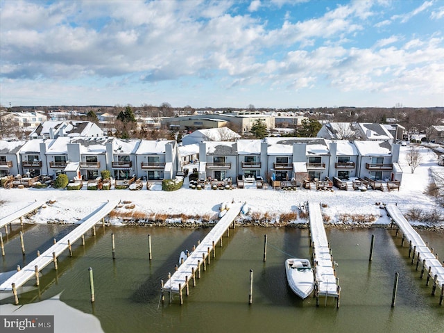 snowy aerial view with a water view