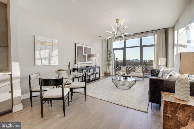 living room with a chandelier and light hardwood / wood-style flooring