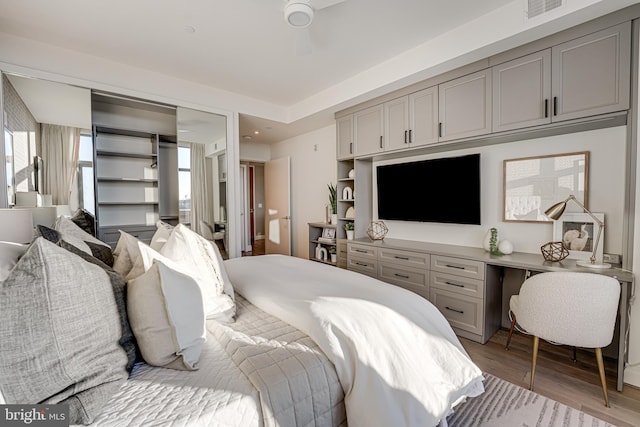 bedroom featuring ceiling fan, a closet, and light hardwood / wood-style flooring