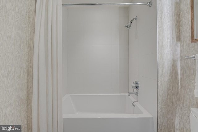 bathroom with shower / bath combo with shower curtain and toilet