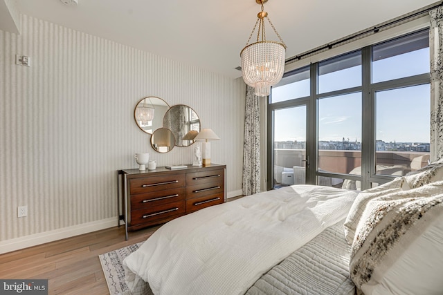 bedroom featuring a notable chandelier and light hardwood / wood-style flooring