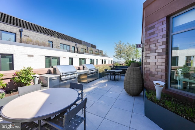 view of patio with area for grilling and a grill