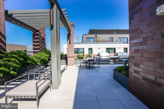 view of patio featuring area for grilling and a pergola