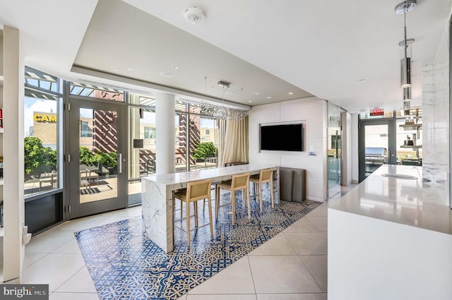 dining room featuring light tile patterned floors and floor to ceiling windows