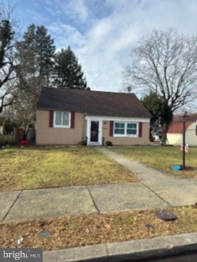 ranch-style house with a front lawn