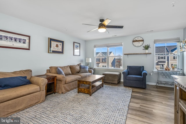 living room featuring ceiling fan and wood-type flooring