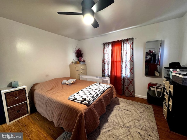 bedroom with ceiling fan and wood finished floors