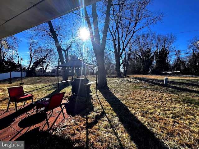 view of yard with fence and a gazebo