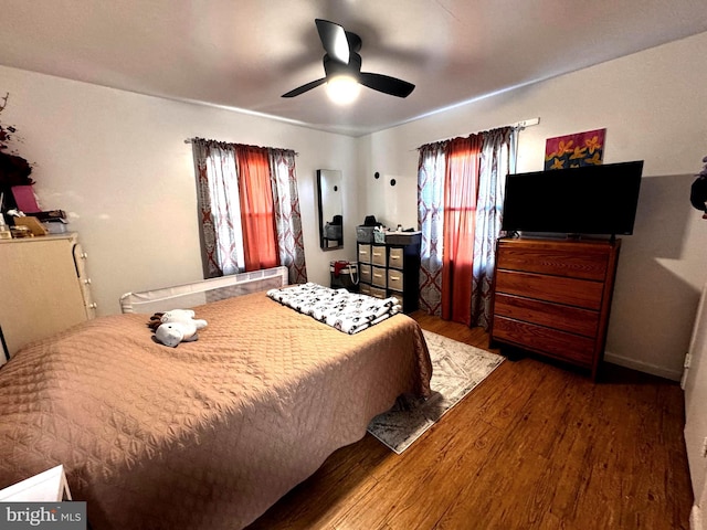 bedroom with a ceiling fan and wood finished floors