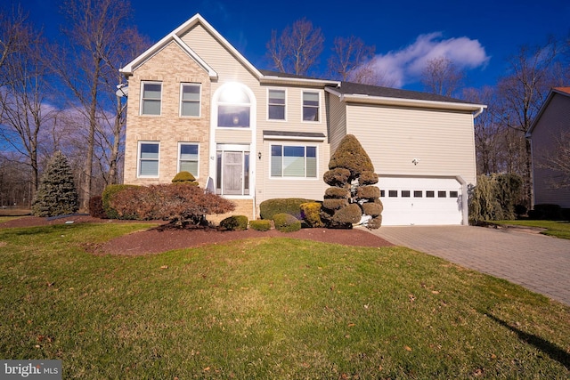 view of property featuring a garage and a front lawn