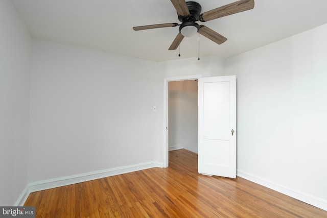 empty room with wood-type flooring and ceiling fan