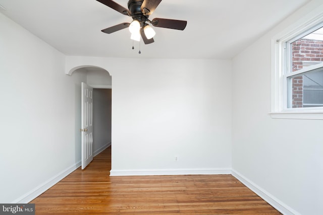 empty room with ceiling fan and light wood-type flooring