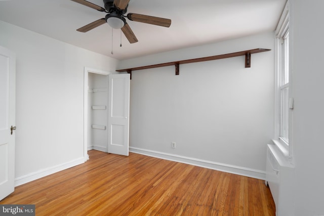 unfurnished bedroom with a closet, ceiling fan, and light wood-type flooring