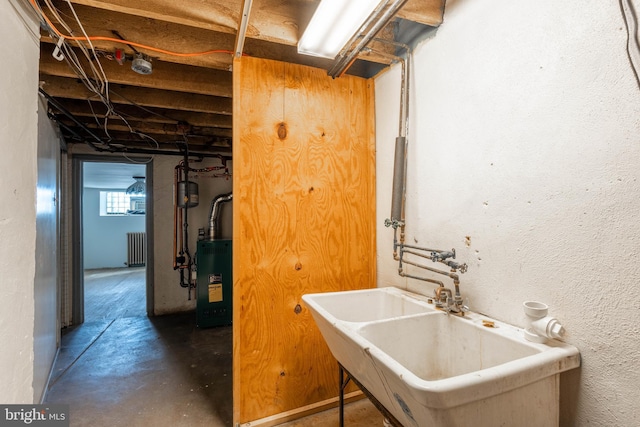 laundry area with radiator and sink