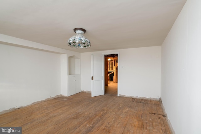 unfurnished room with wood-type flooring