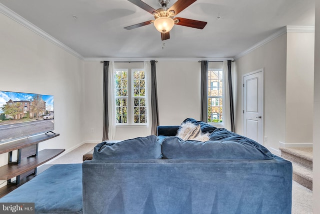 living room featuring carpet, ceiling fan, crown molding, and a wealth of natural light