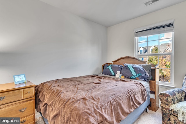 bedroom with light carpet and multiple windows