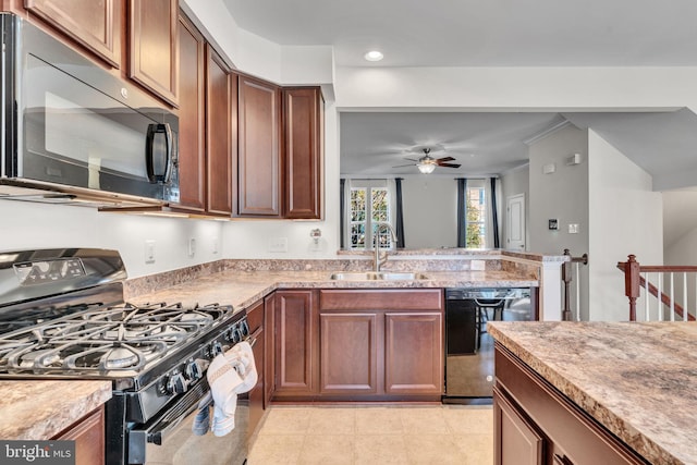 kitchen with light stone countertops, sink, ceiling fan, and black appliances