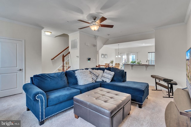 carpeted living room featuring ceiling fan and crown molding