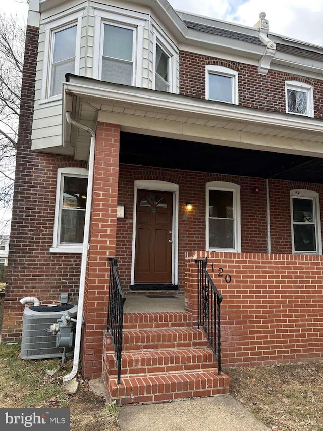 property entrance featuring central AC unit