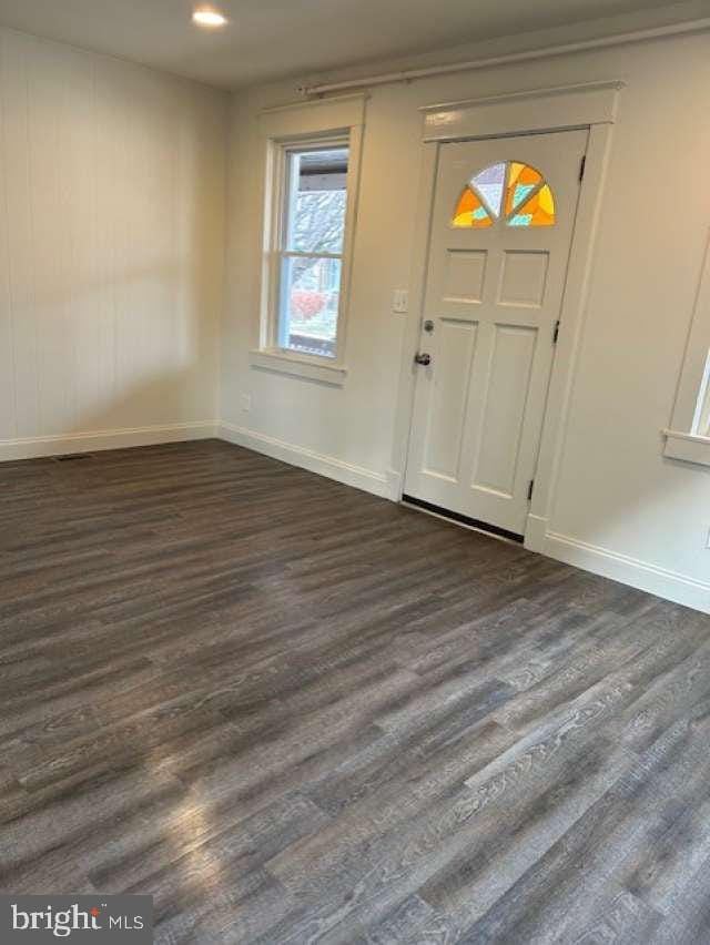 foyer entrance featuring dark hardwood / wood-style floors