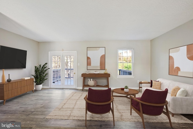 living area featuring hardwood / wood-style floors and a textured ceiling