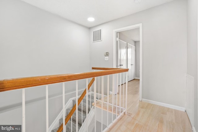 hallway with light hardwood / wood-style floors