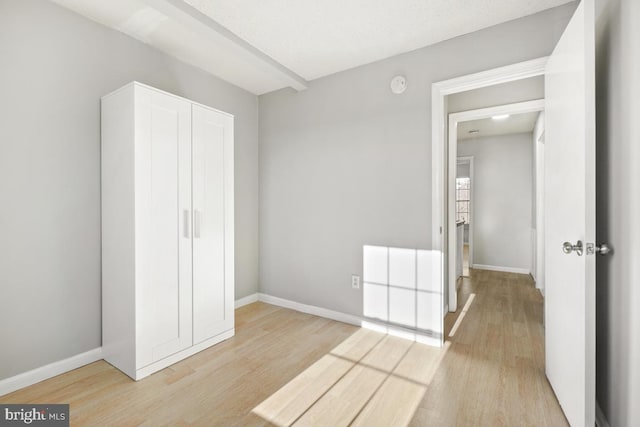 unfurnished bedroom with a closet and light hardwood / wood-style floors