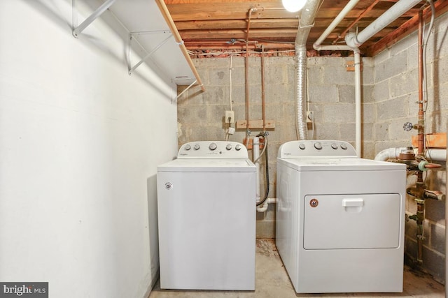 clothes washing area featuring washer and dryer