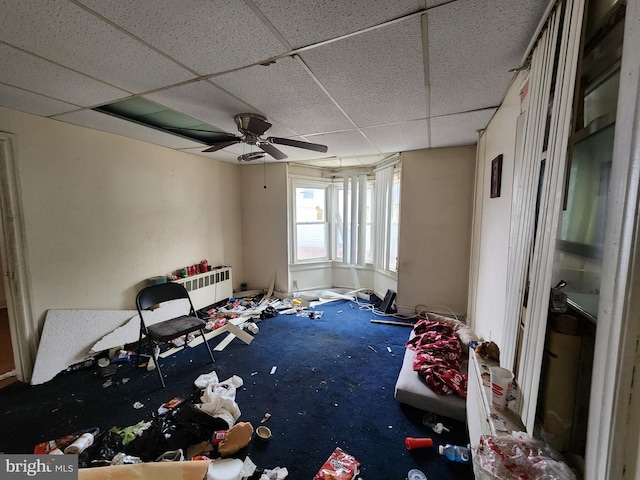 unfurnished bedroom featuring a paneled ceiling, ceiling fan, and carpet floors