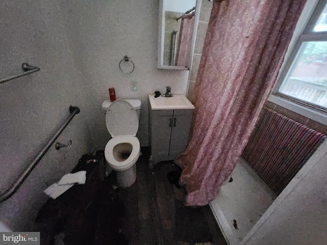 bathroom with walk in shower, sink, hardwood / wood-style floors, and toilet