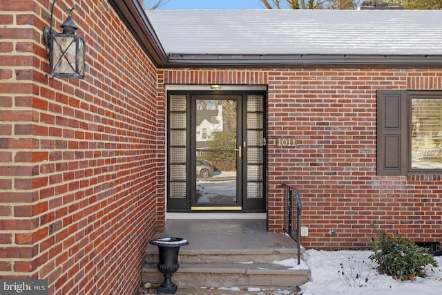 view of snow covered property entrance